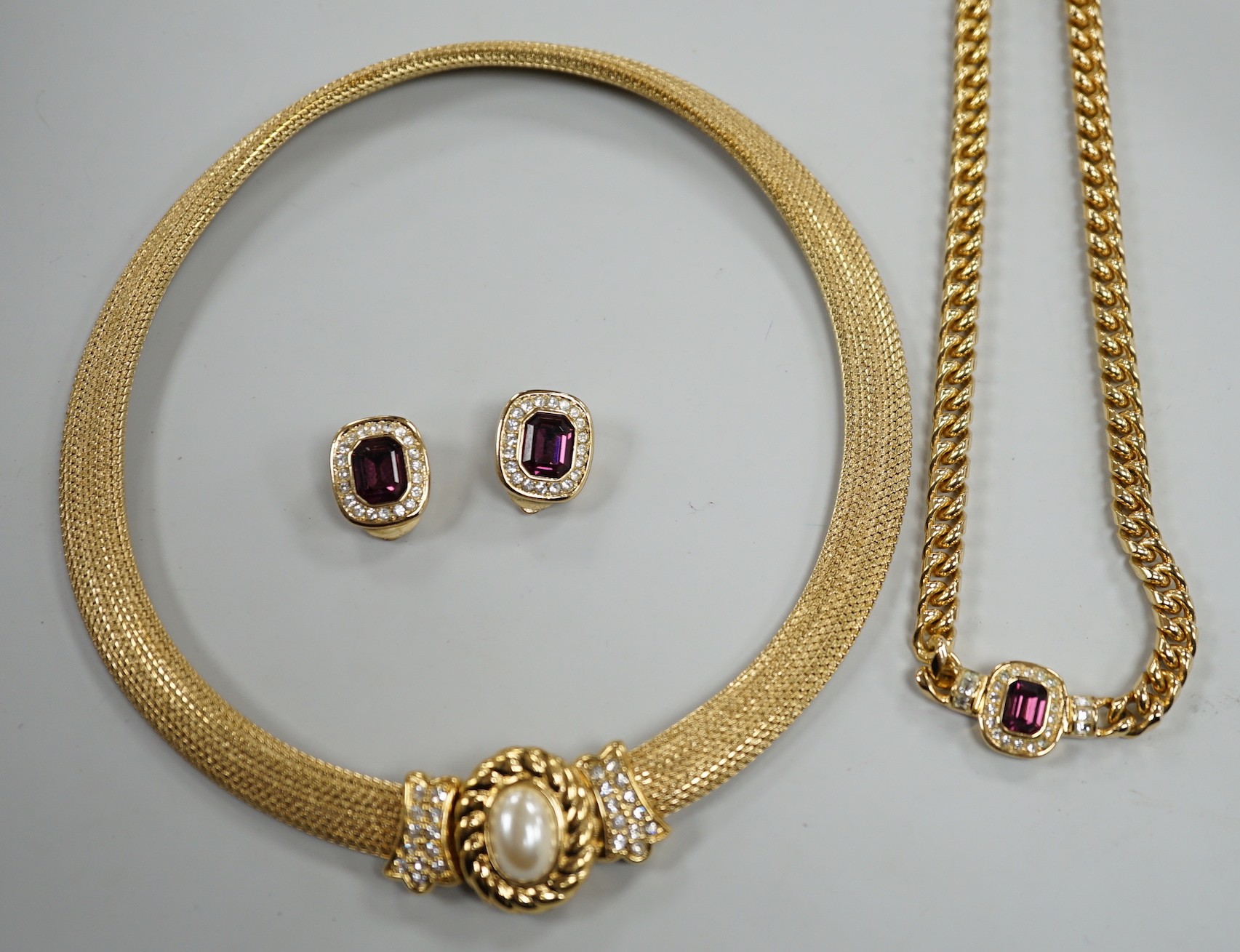 A modern Christian Dior gilt metal and two colour paste set necklace, 37cm and a pair of matching ear clips and one other Christian Dior necklace.
